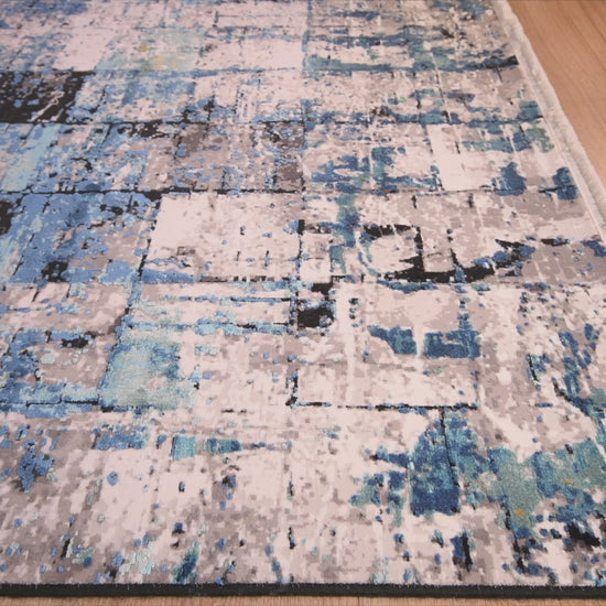 Tapete decorativo colección Civita rectangular en tonos turquesa, gris y oro