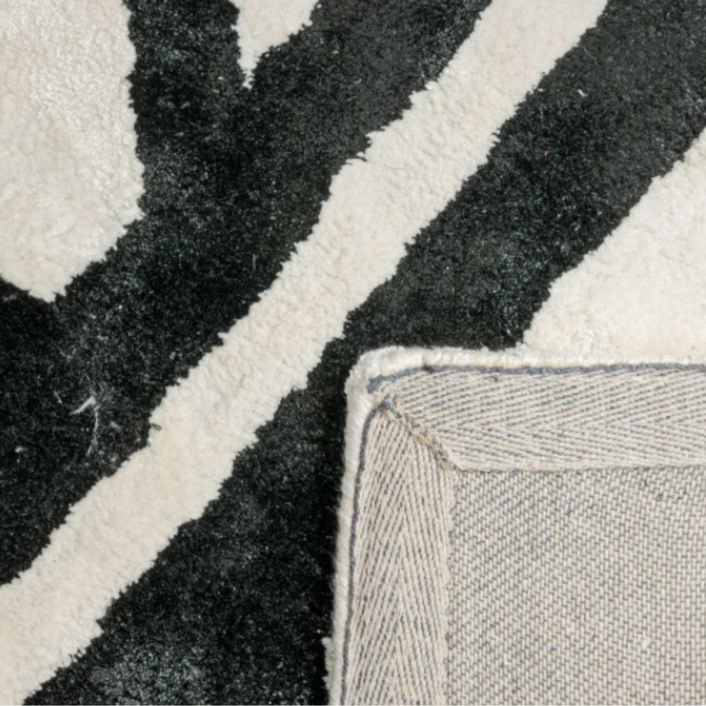 Tapete decorativo colección Gaya rectangular en viscosa y algodón marfil con negro de pelo corto